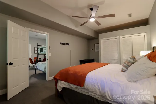 a bedroom with a large bed and a chandelier