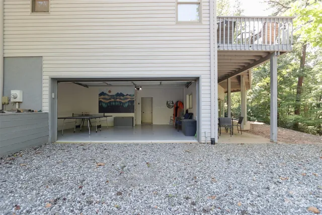 a view of a porch with a table and chairs