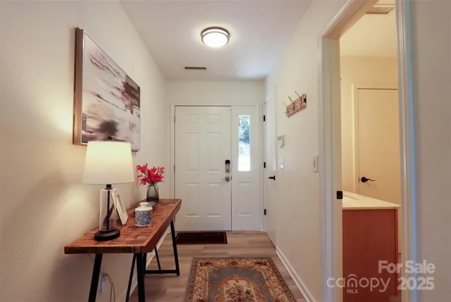 a view of a room with furniture and wooden floor