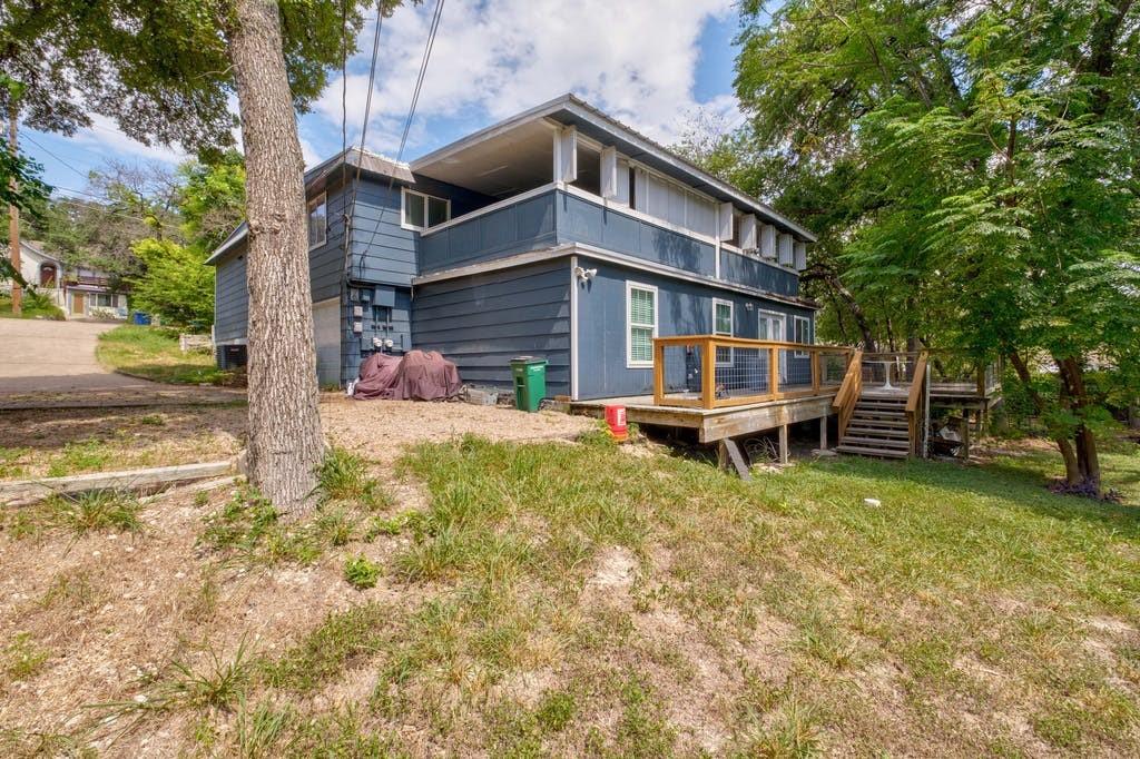 a backyard of a house with table and chairs