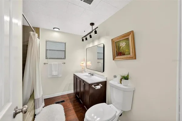 a bathroom with a double vanity sink a mirror and a shower