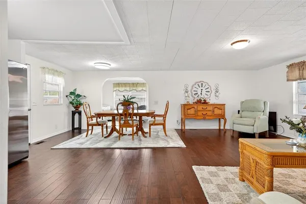 a dining room with furniture and wooden floor