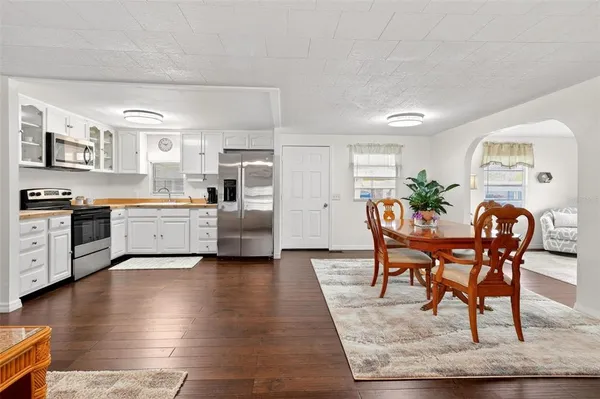 a view of a dining room with furniture and wooden floor