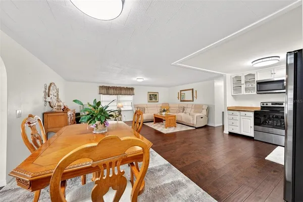 a living room with furniture and kitchen view