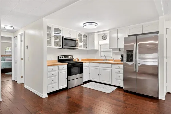a kitchen with stainless steel appliances a refrigerator stove and microwave