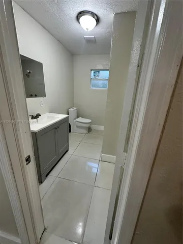 a bathroom with a sink a toilet and mirror
