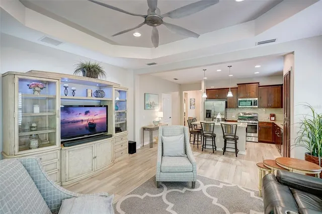 a kitchen with stainless steel appliances granite countertop a sink a stove and a wooden floors