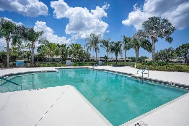 a view of a swimming pool with a table and chairs