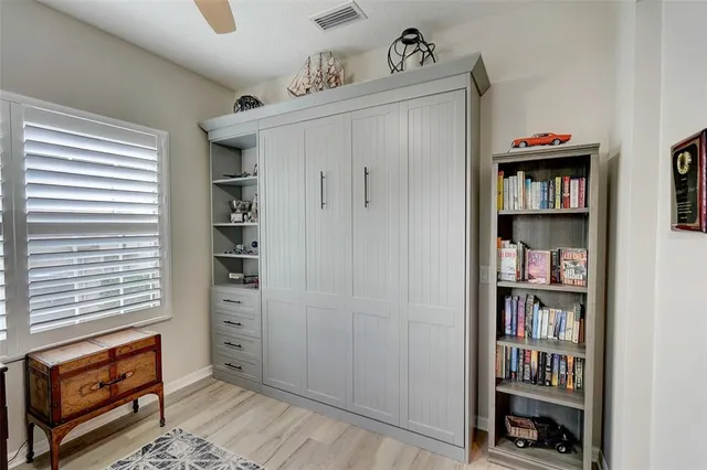 a dining hall with stainless steel appliances granite countertop a stove top oven a dining table and chairs