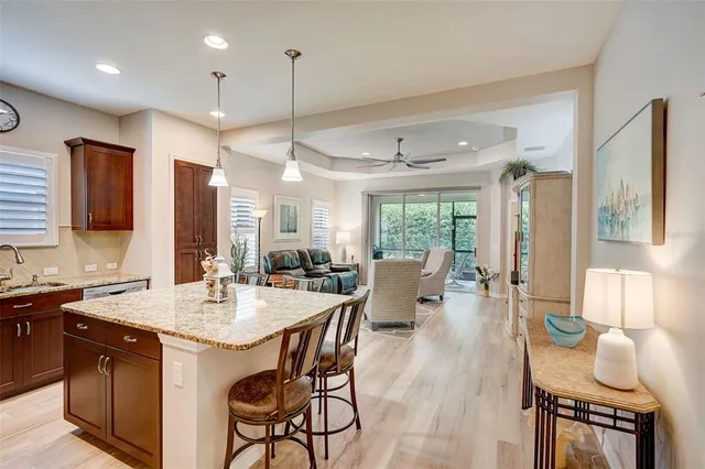 a kitchen with granite countertop kitchen island a dining table and chairs