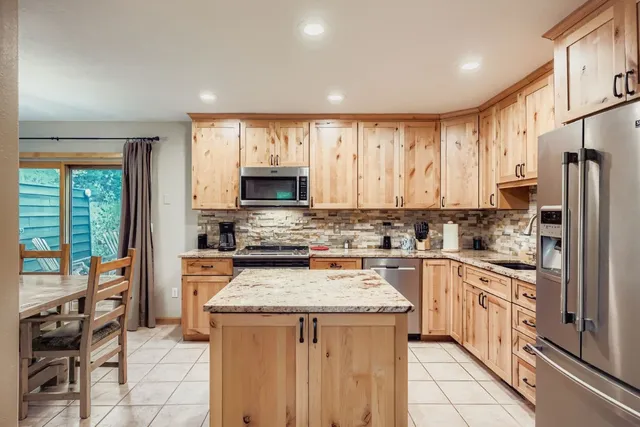 a kitchen with a stove a sink and a refrigerator