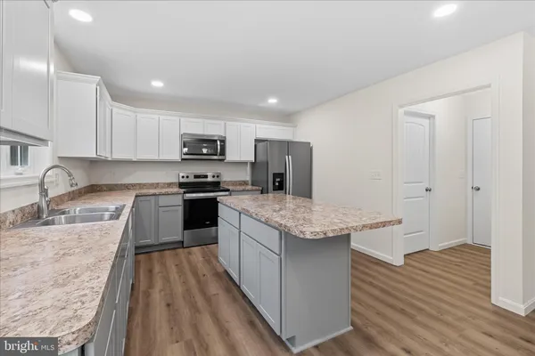 a kitchen with granite countertop stainless steel appliances and wooden cabinets