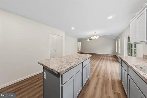 a kitchen with a sink and wooden floor