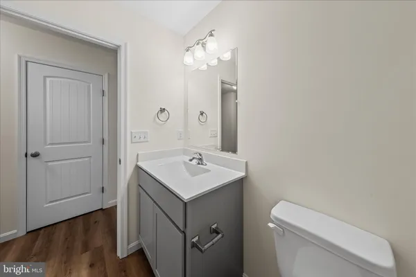 a bathroom with a toilet a sink and mirror