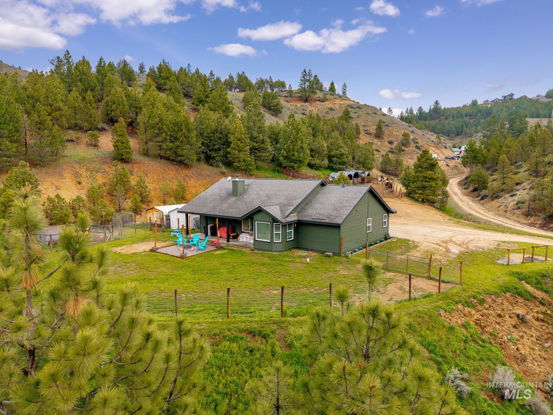 4 Round Up Circle Boise, ID 83716 - Photo 3 of 47 Ranch-style residence featuring a dark green exterior siding and a dark shingle roof
