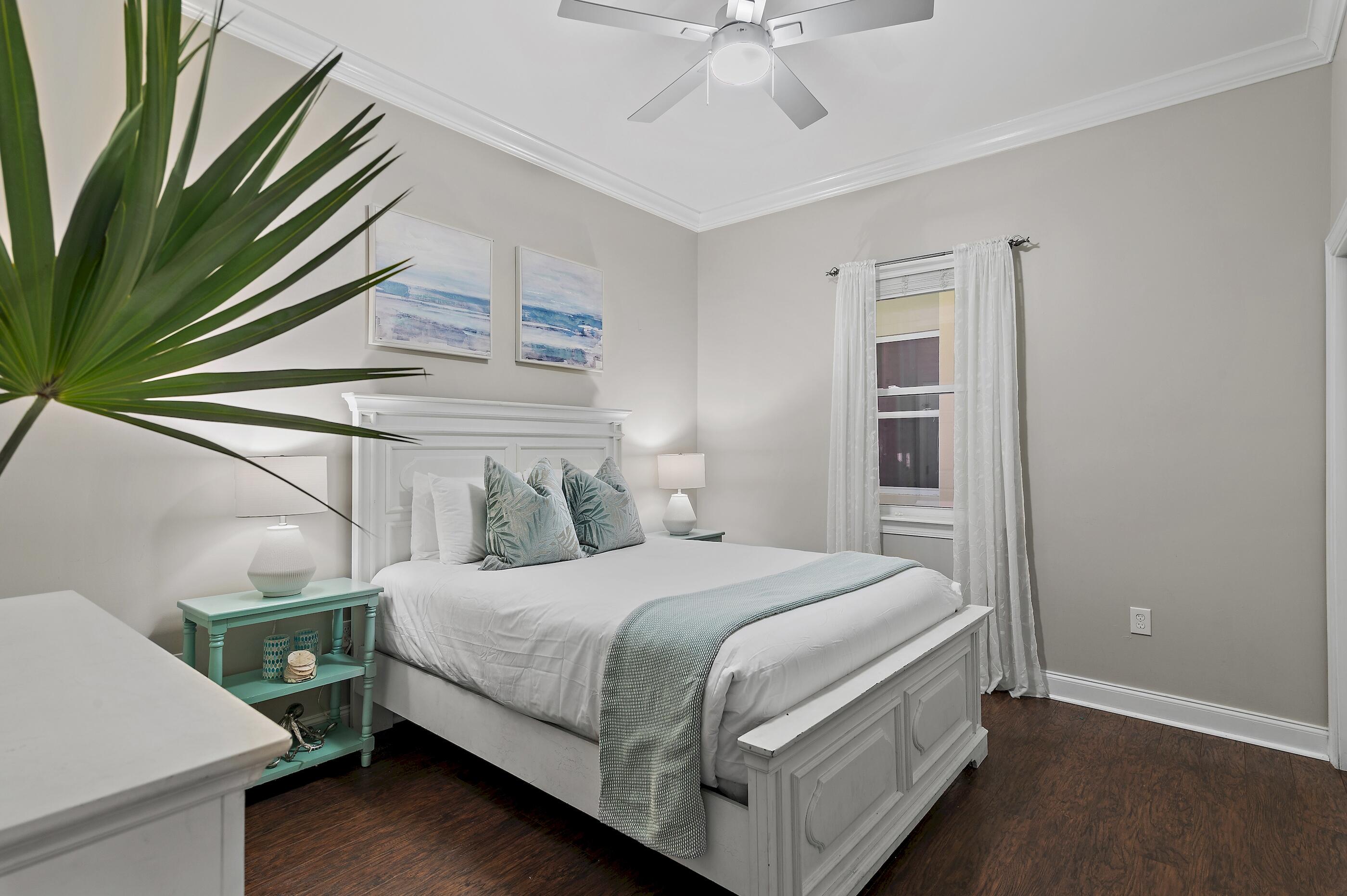 231 Somerset Bridge Road, Unit 2107 Santa Rosa Beach, FL 32459 - Photo 12 of 47 a bedroom with a bed and a chandelier