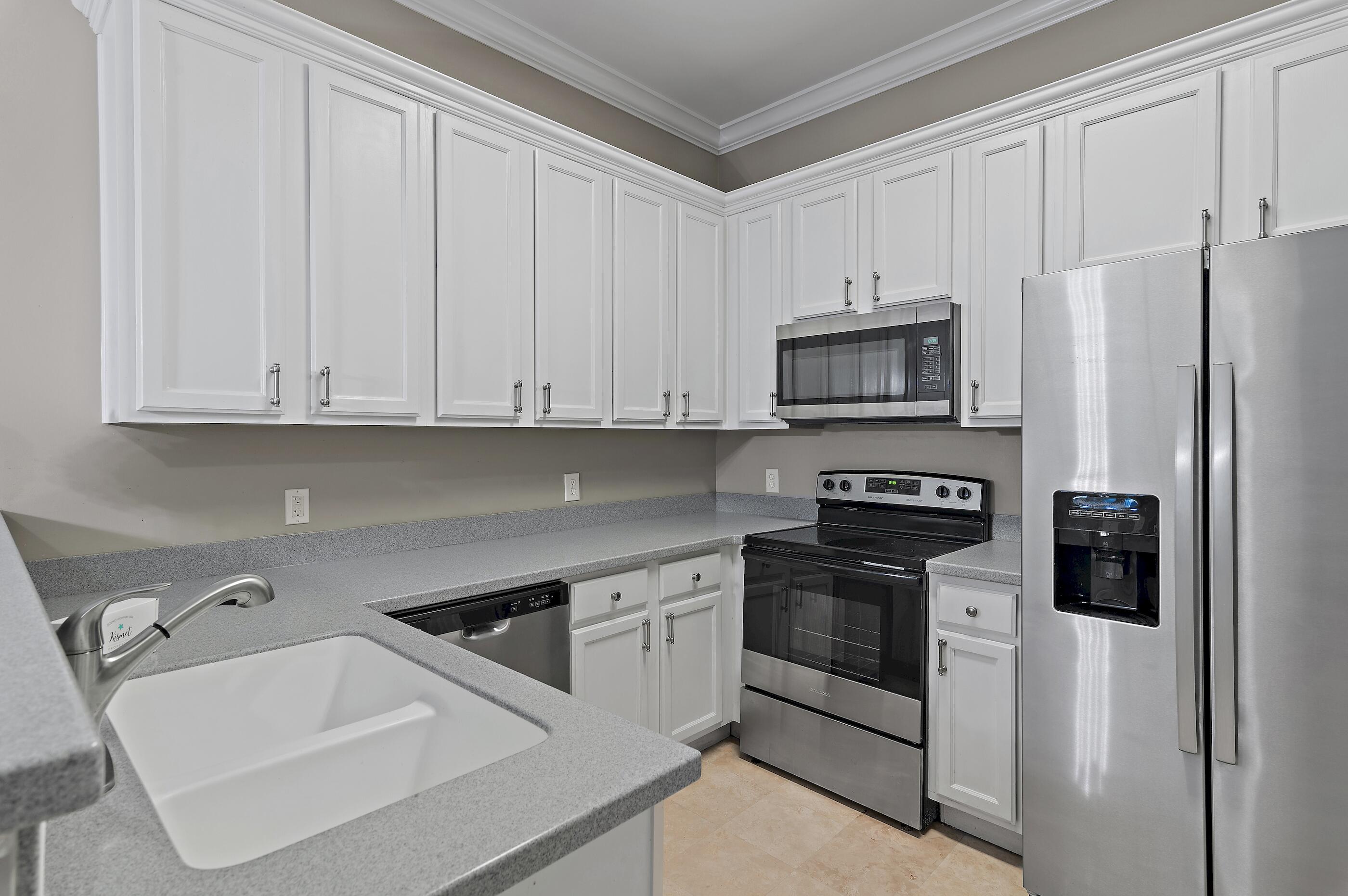 231 Somerset Bridge Road, Unit 2107 Santa Rosa Beach, FL 32459 - Photo 10 of 47 a kitchen with stainless steel appliances granite countertop a refrigerator stove a sink and dishwasher with white cabinets