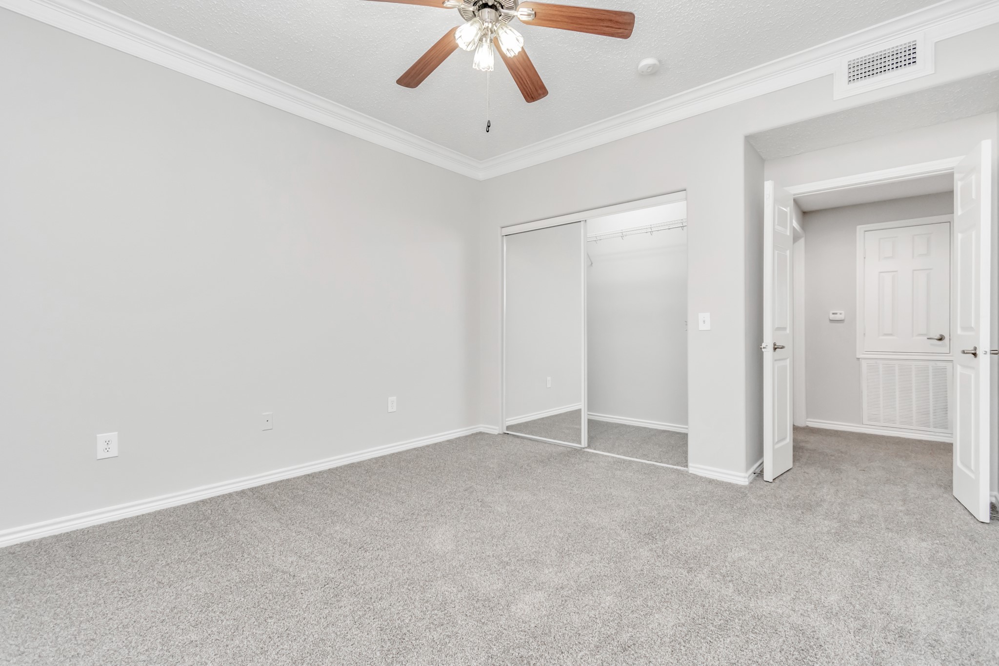 1600 Eldridge Parkway South, Unit 3205 Houston, TX 77077 - Photo 25 of 38 an empty room with a ceiling fan and carpet