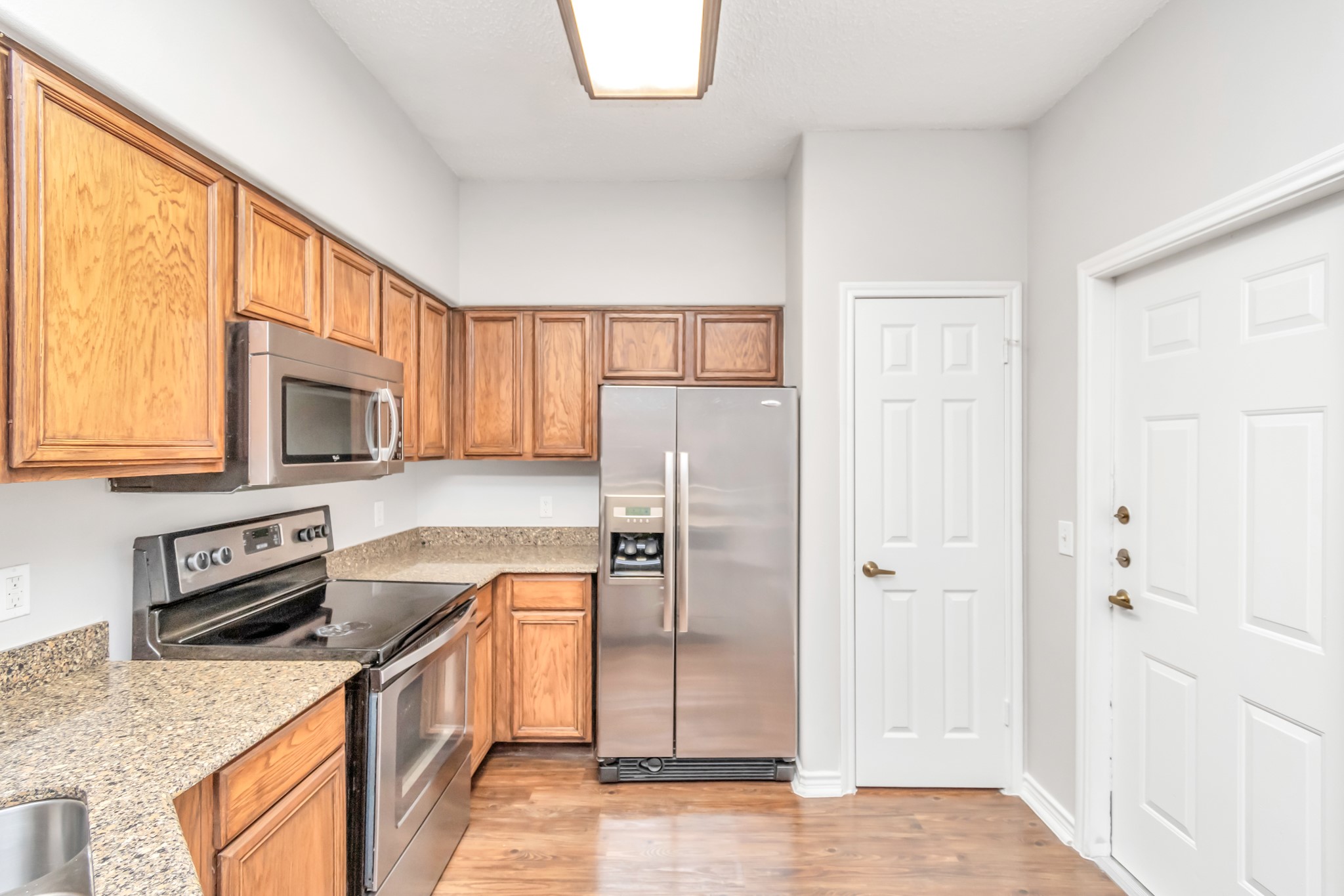 1600 Eldridge Parkway South, Unit 3205 Houston, TX 77077 - Photo 8 of 38 a kitchen with stainless steel appliances granite countertop a refrigerator stove and sink