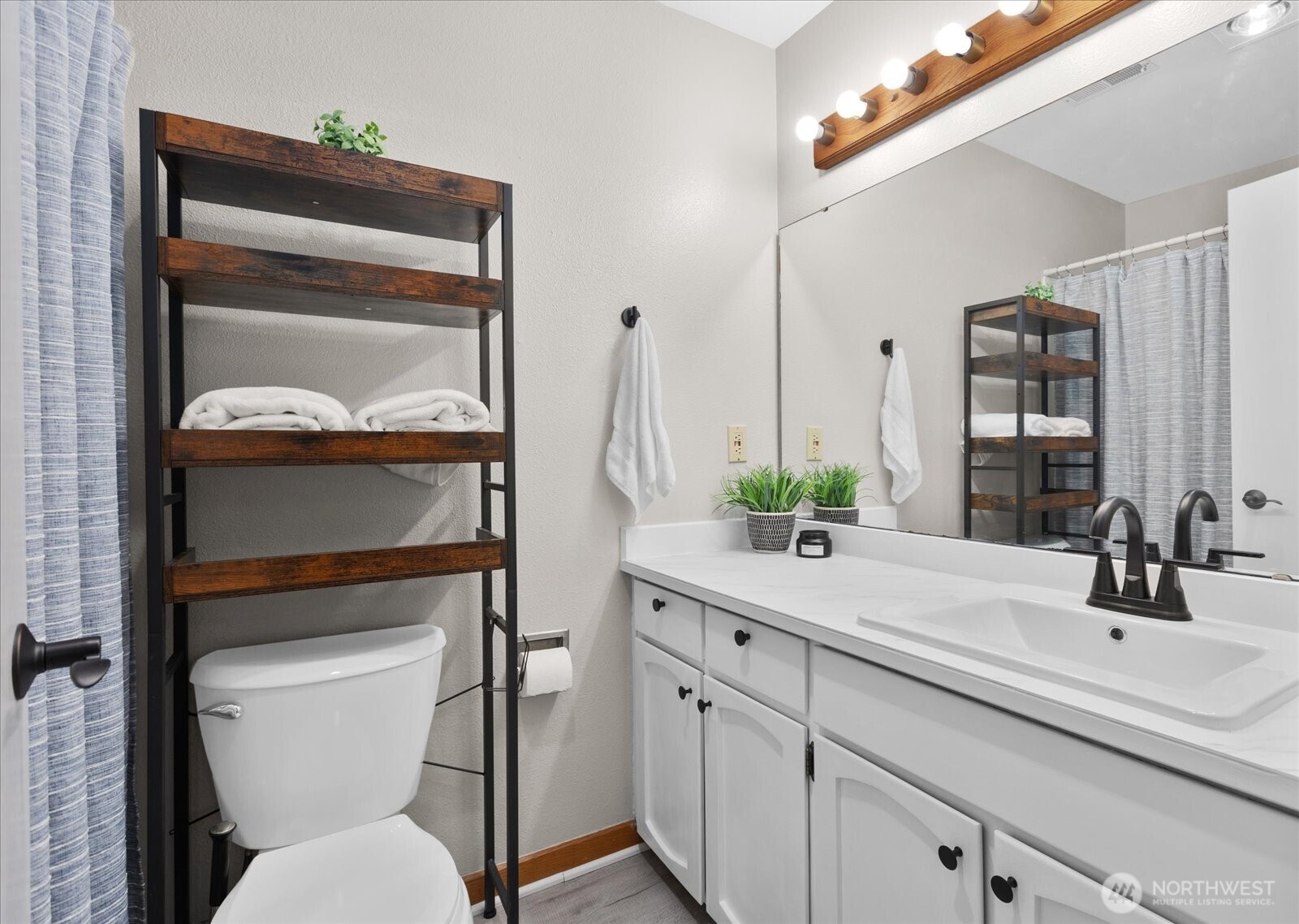 4120 212th Street Southwest, Unit B206 Mountlake Terrace, WA 98043 - Photo 14 of 20 a bathroom with a toilet sink and mirror