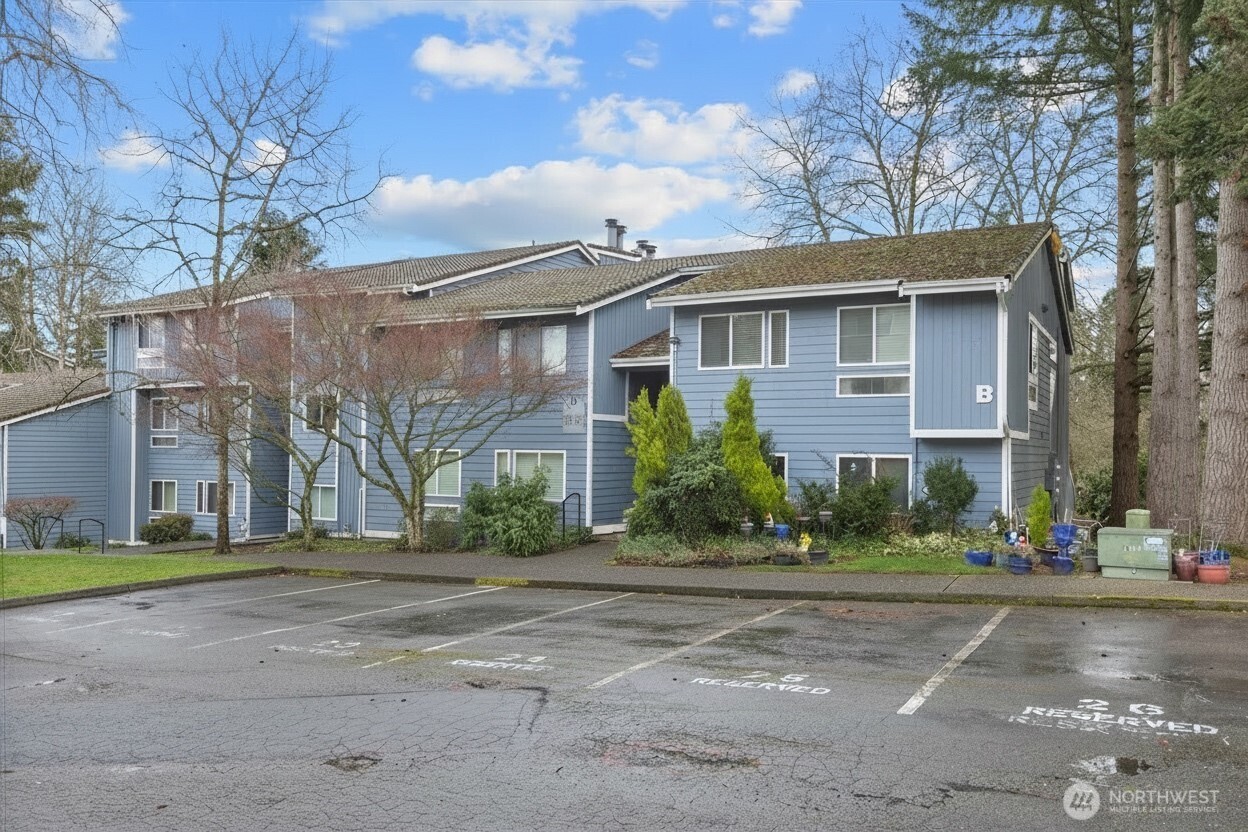 4120 212th Street Southwest, Unit B206 Mountlake Terrace, WA 98043 - Photo 2 of 20 a front view of a house with a yard