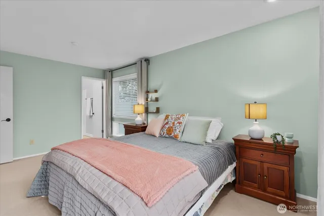 a bedroom with a bed and lamps