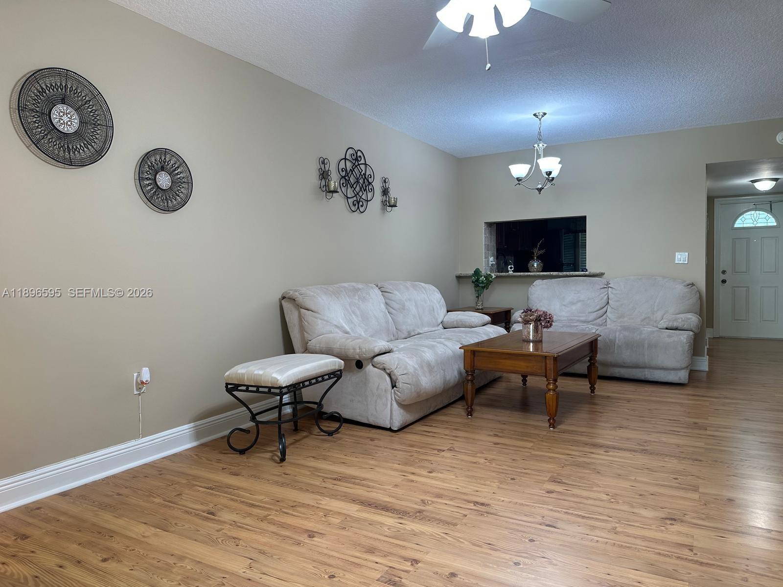 9848 Marina Boulevard, Unit 811 Boca Raton, FL 33428 - Photo 20 of 86 a living room with furniture and a wooden floor