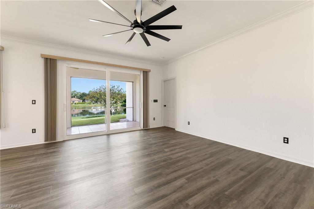 223 Stanhope Circle Naples, FL 34104 - Photo 4 of 41 Spacious interior featuring wood-finish flooring, white walls, and crown molding