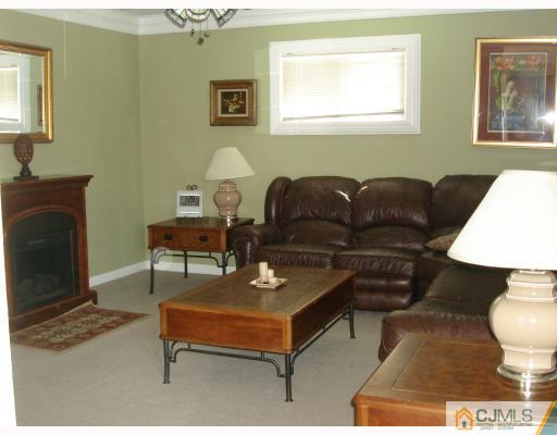 29 Cambridge Road Edison, NJ 08817 - Photo 2 of 10 a living room with furniture and a fireplace