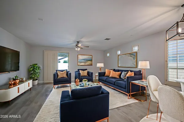 a living room with furniture flat screen tv and window