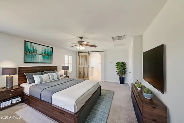 a bedroom with a bed and a flat screen tv