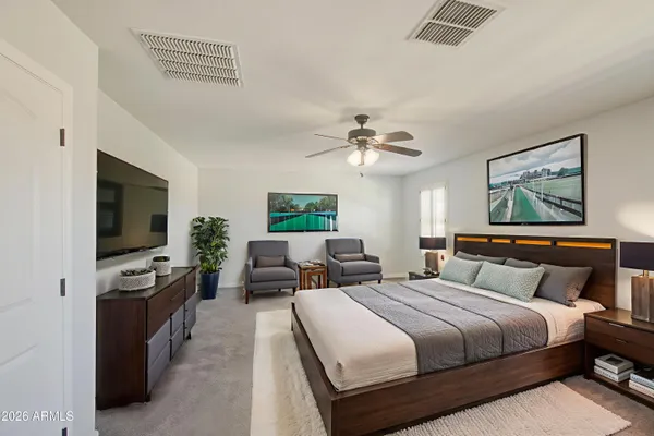 a bedroom with a bed and a flat screen tv