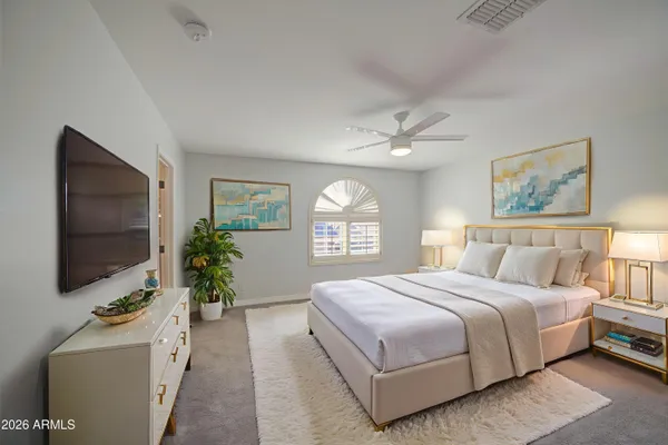 a bedroom with a large bed and a flat screen tv