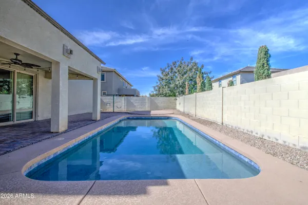 a view of a backyard with swimming pool
