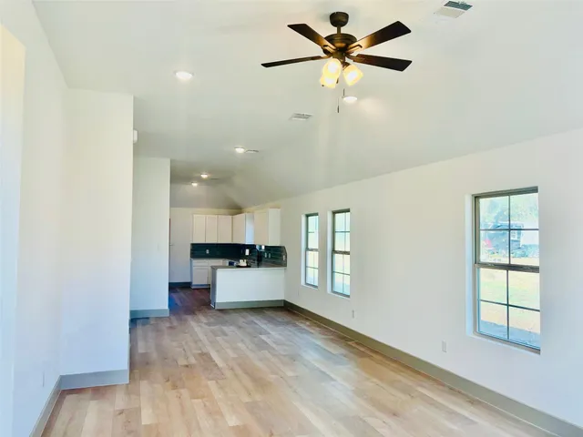 a view of a kitchen with furniture and a ceiling fan