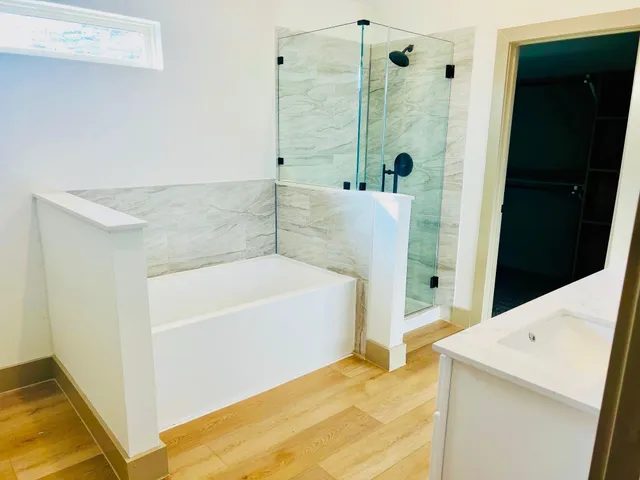 a bathroom with a tub and shower