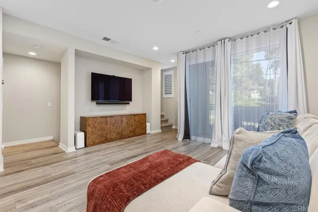 a bedroom with a bed and a flat screen television