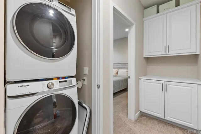 a view of a storage and utility room with washer and dryer