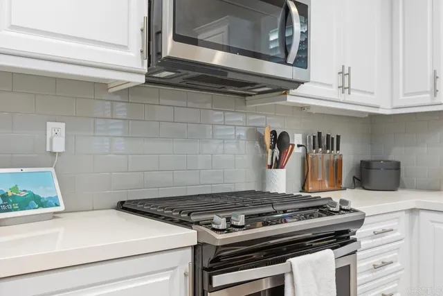 a stove top oven sitting inside of a kitchen