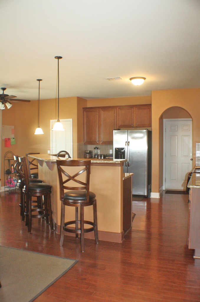 26 Riverside Landing Fort Mitchell, AL 36856 - Photo 24 of 65 a open kitchen with stainless steel appliances kitchen island granite countertop a table chairs and a refrigerator
