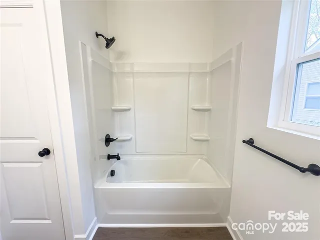 a bathroom with bathtub and shower