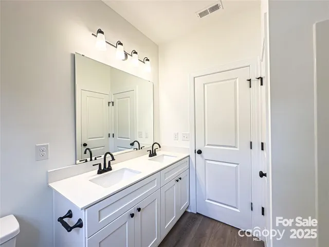 a bathroom with a sink vanity and a mirror
