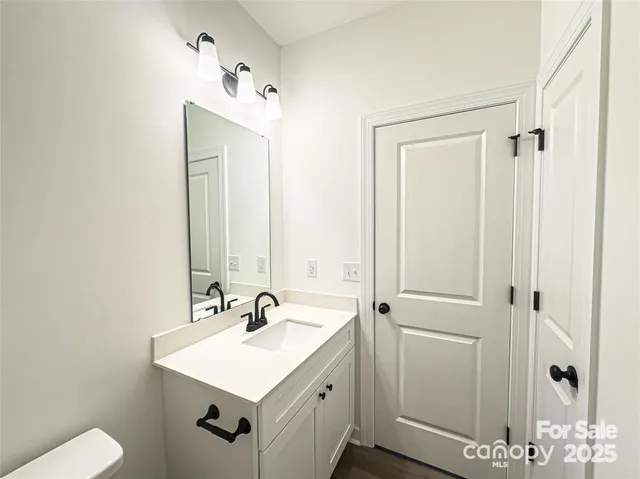 a bathroom with a sink vanity and a mirror