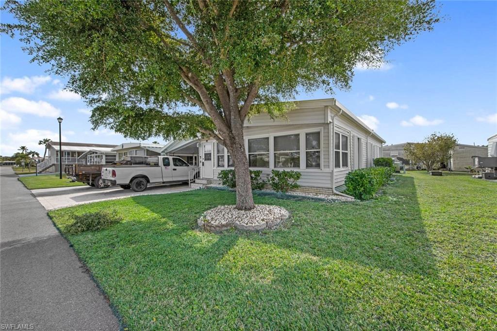 a front view of a house with a garden
