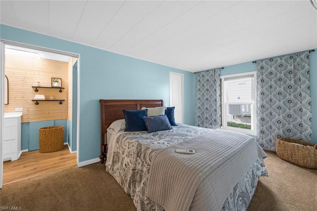 28 Enchanting Boulevard, Unit E28 Naples, FL 34112 - Photo 13 of 28 a bedroom with a bed and a couch