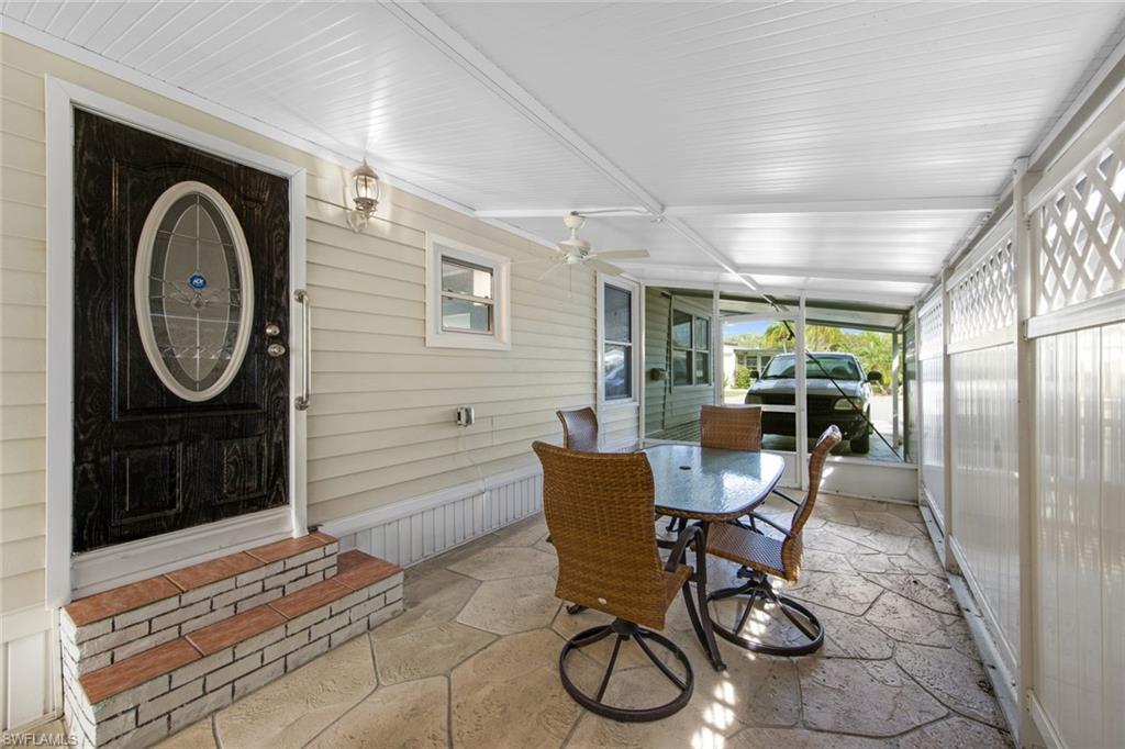 28 Enchanting Boulevard, Unit E28 Naples, FL 34112 - Photo 26 of 28 a view of a dining room with furniture a rug and wooden floor