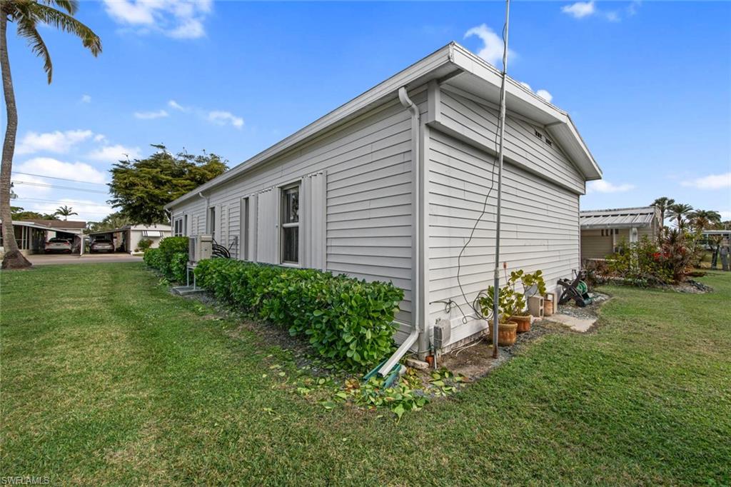 28 Enchanting Boulevard, Unit E28 Naples, FL 34112 - Photo 28 of 28 a backyard of a house with table and chairs with plants