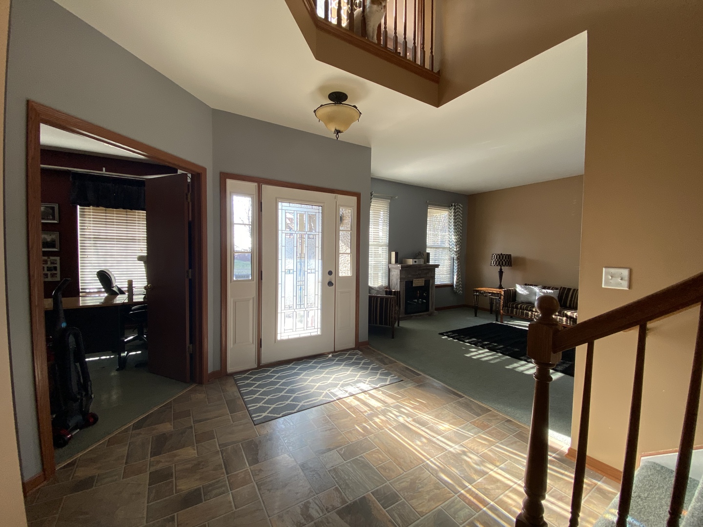 215 Wilkins Road Sycamore, IL 60178 - Photo 11 of 28 a view of a hallway to a livingroom with furniture window and wooden floor