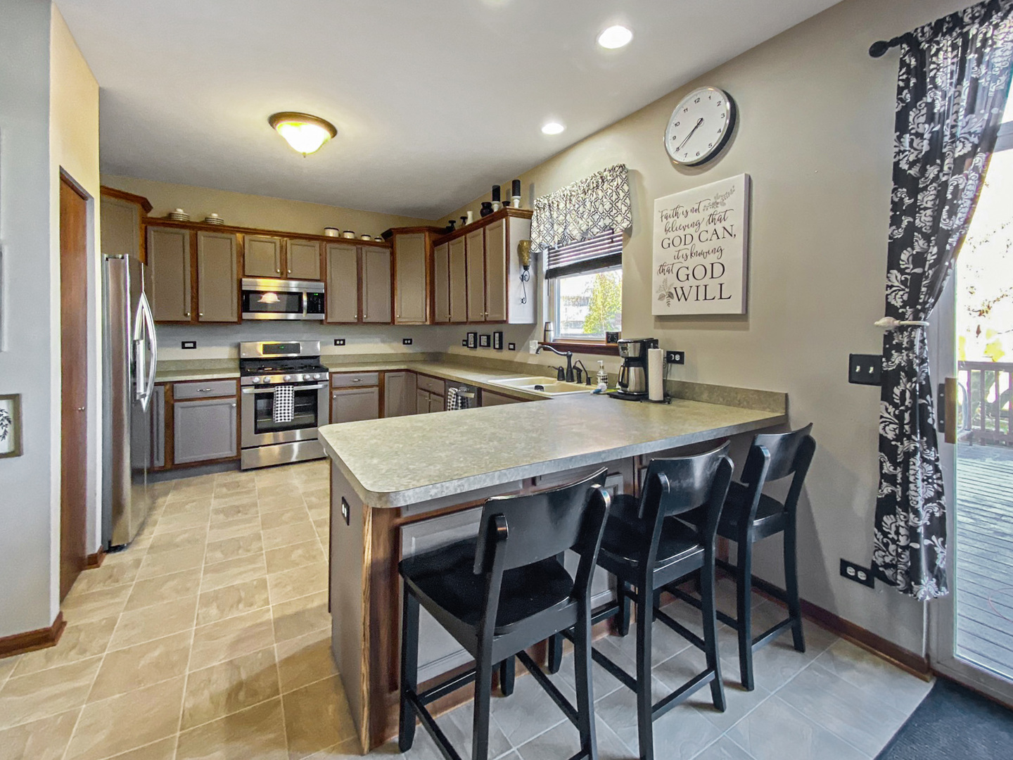 215 Wilkins Road Sycamore, IL 60178 - Photo 3 of 28 a kitchen with stainless steel appliances granite countertop a stove a refrigerator a sink a dining table and chairs with wooden floor