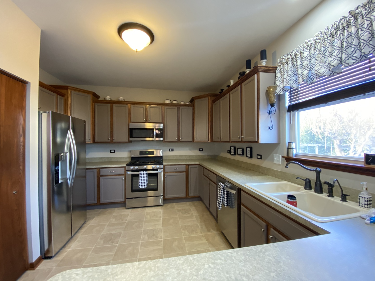 215 Wilkins Road Sycamore, IL 60178 - Photo 5 of 28 a kitchen with stainless steel appliances granite countertop a sink stove and refrigerator